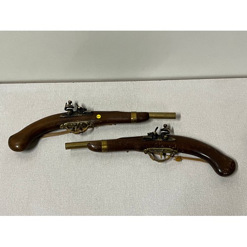 141 - a pair of wall hanging pistols