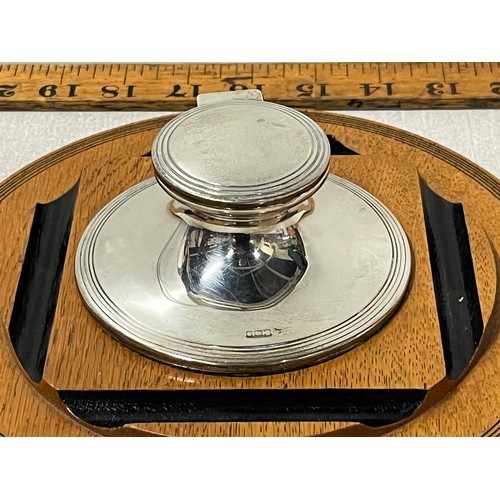 139 - Hallmarked silver captains inkwell to include insert on wooden desk stand.