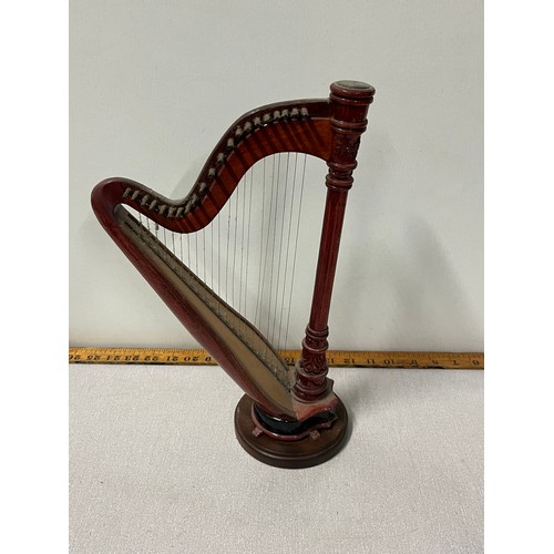 524 - Miniature wooden harp on stand.