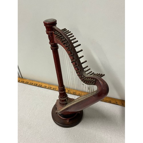 524 - Miniature wooden harp on stand.