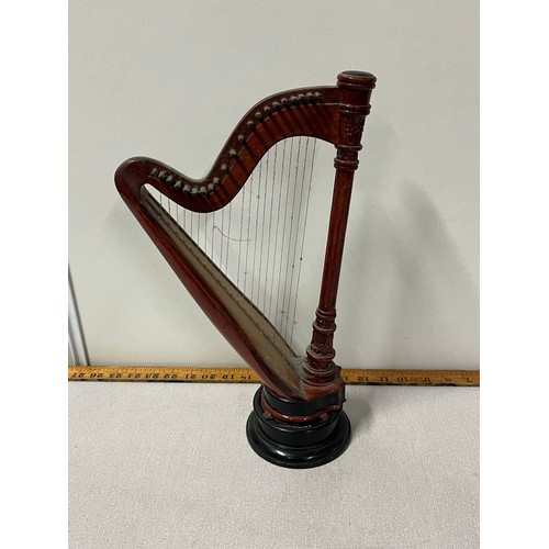 525 - Miniature wooden harp on stand.