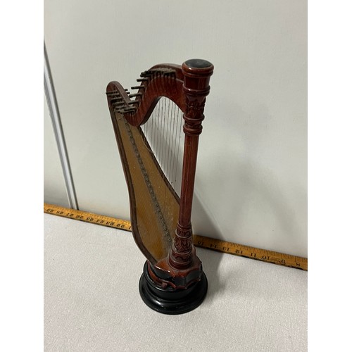 525 - Miniature wooden harp on stand.