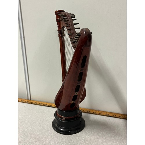 525 - Miniature wooden harp on stand.