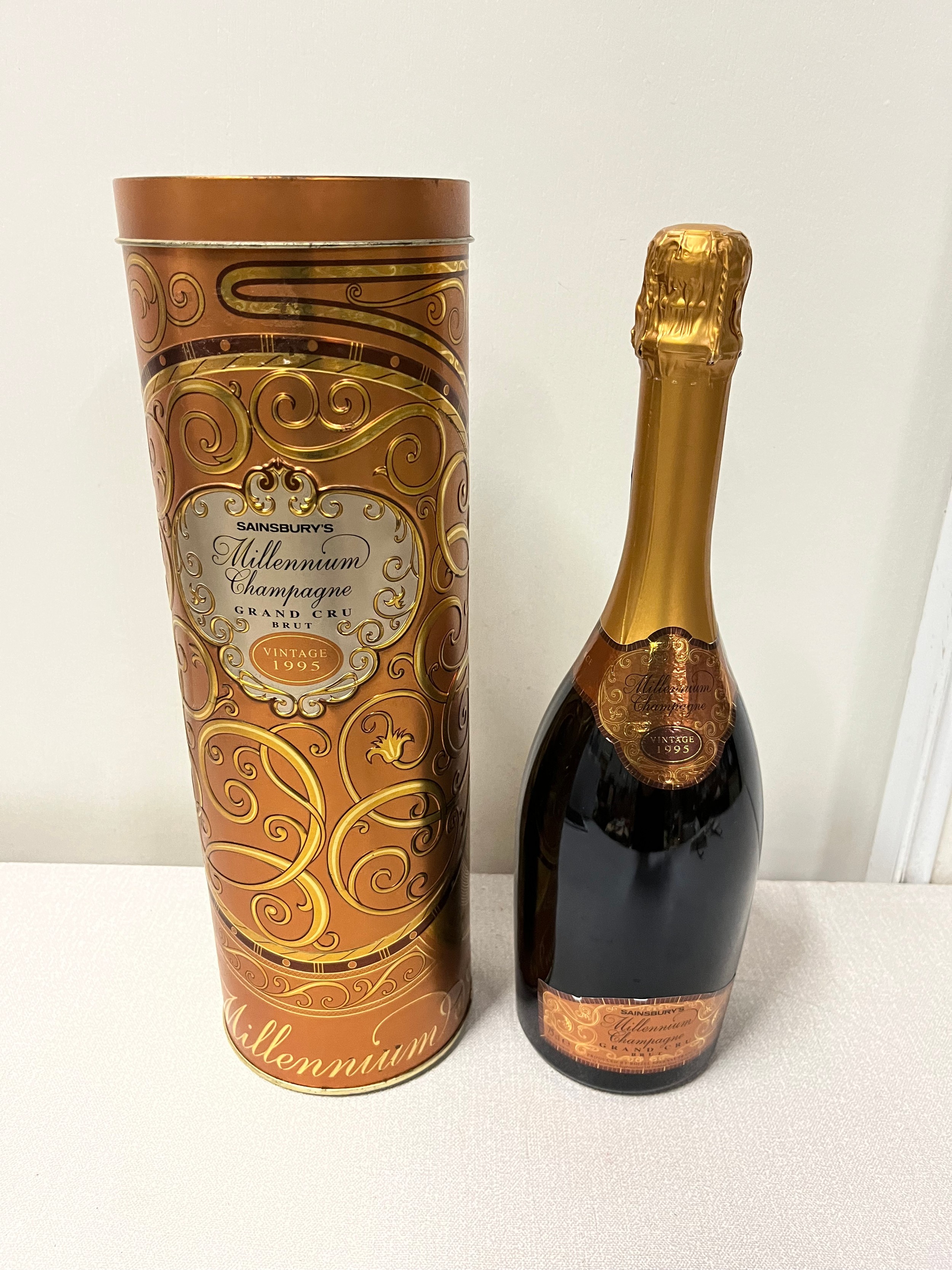 bottle of millenium grand cru brut champagne in the tin