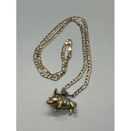 91 - 9ct gold chain with 9ct gold pig 
total weight 23.3 grams
chain 11