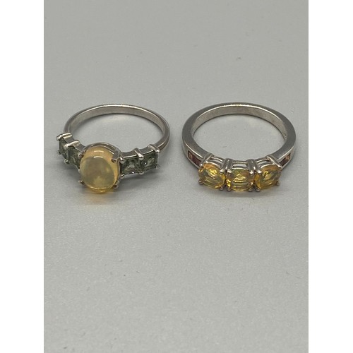 87 - 2 Silver ring with yellow stones.