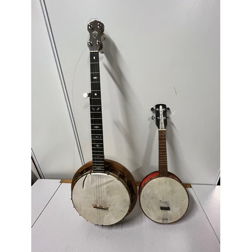 53 - Banjo & ukulele banjo with brass decorative peacock plate on back.