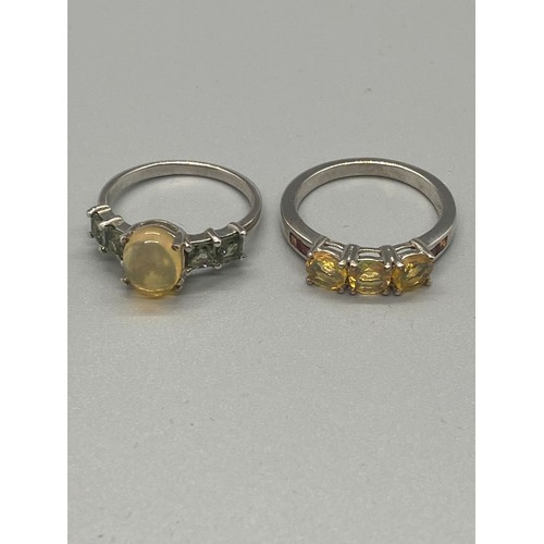 87 - 2 Silver ring with yellow stones.