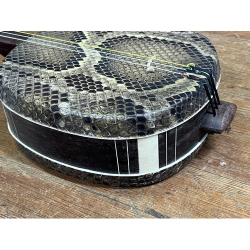 278 - Chinese Sanxian string instrument. Mahogany and snake skin.