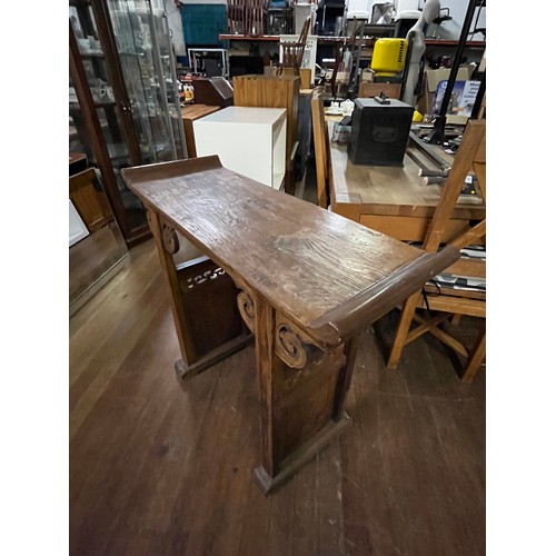 71 - Oriental wooden hall table with scroll design.