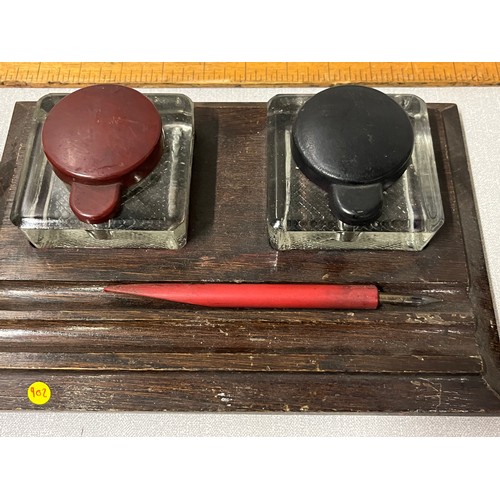 148 - Bakelite desk ink & pen stand along with wooden ink & pen stand.
Largest 26cm l