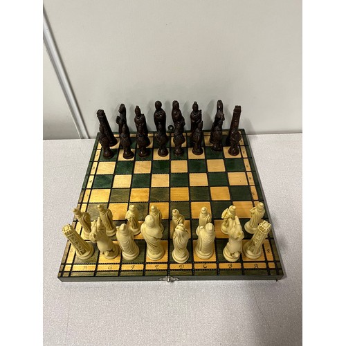 169 - Folding wooden chess set with Roman style pieces.