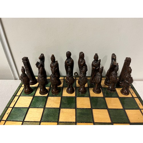 169 - Folding wooden chess set with Roman style pieces.