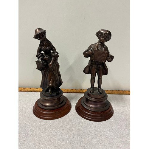 237 - Pair of bronze figurines to include Gentleman playing accordion & lady with basket.