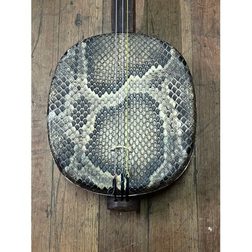 278 - Chinese Sanxian string instrument. Mahogany and snake skin with fitted hard case.