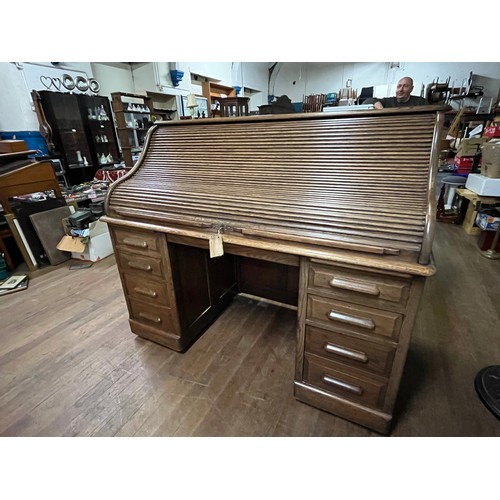 51 - Early 20th century light oak roll top desk, the tambour front opening to display compartments and wr... 