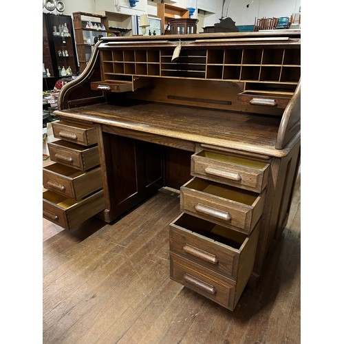 51 - Early 20th century light oak roll top desk, the tambour front opening to display compartments and wr... 