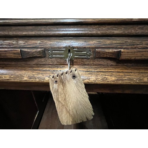 51 - Early 20th century light oak roll top desk, the tambour front opening to display compartments and wr... 