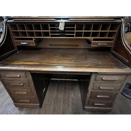 51 - Early 20th century light oak roll top desk, the tambour front opening to display compartments and wr... 