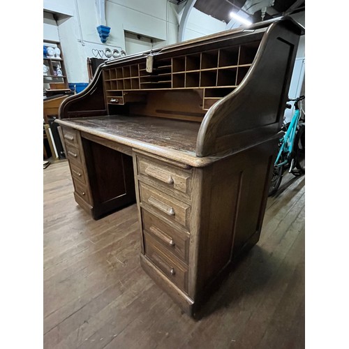 51 - Early 20th century light oak roll top desk, the tambour front opening to display compartments and wr... 