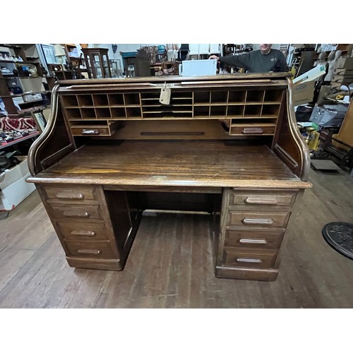 51 - Early 20th century light oak roll top desk, the tambour front opening to display compartments and wr... 