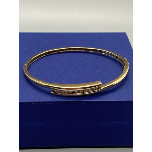 34 - 9ct gold bangle set with 9 diamonds 12.7g