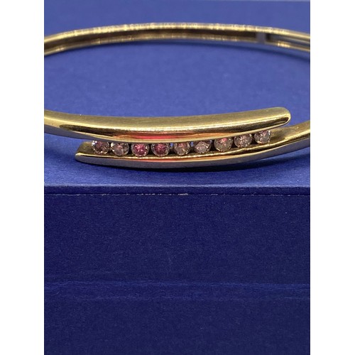 34 - 9ct gold bangle set with 9 diamonds 12.7g