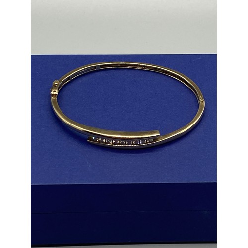 34 - 9ct gold bangle set with 9 diamonds 12.7g