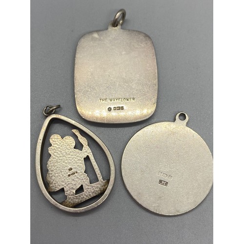 243 - 3 large silver hallmarked pendants to include the may flower and 2 St.Christophers