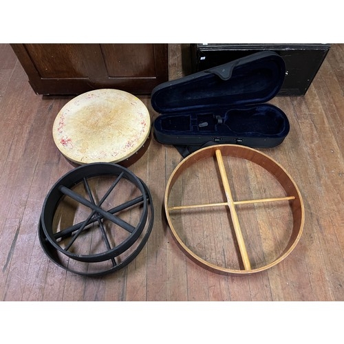 115 - Goat skin Bodhran along with with 3 skinless bodhrans & violin case.