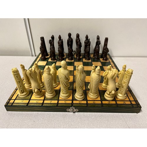 169 - Folding wooden chess set with Roman style pieces.