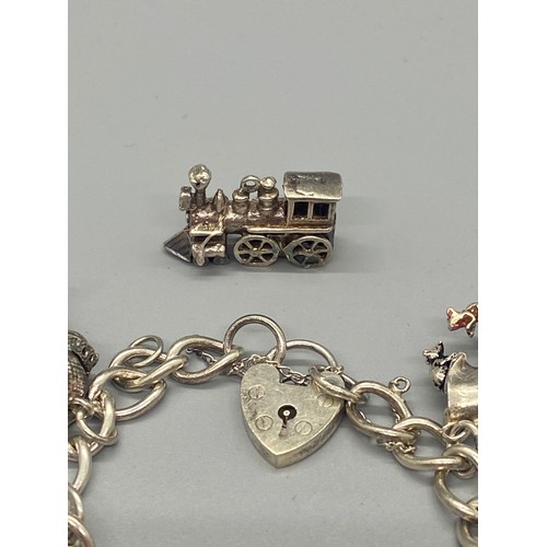 156 - silver charm bracelet with 10 charms