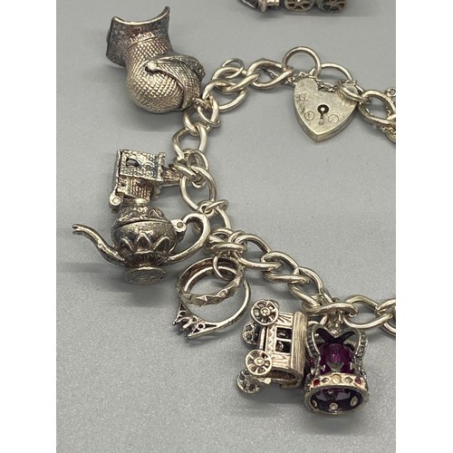 156 - silver charm bracelet with 10 charms