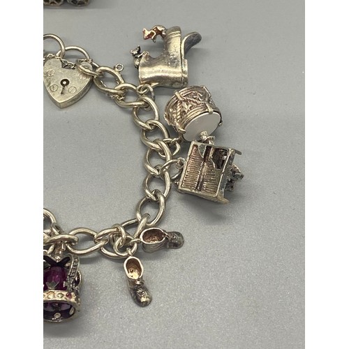 156 - silver charm bracelet with 10 charms