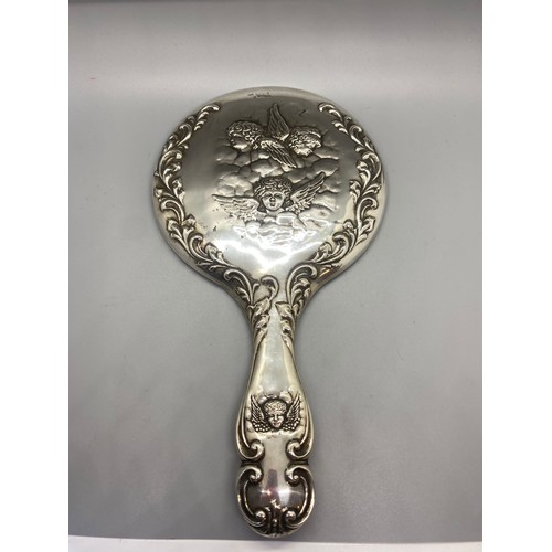 30 - Antique hallmarked silver hand mirror with cherub design.