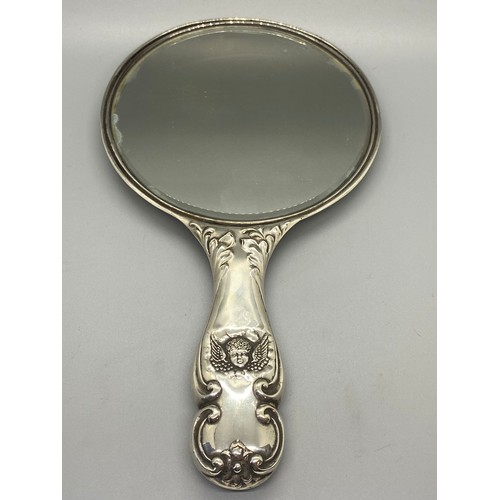 30 - Antique hallmarked silver hand mirror with cherub design.