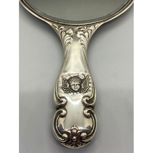 30 - Antique hallmarked silver hand mirror with cherub design.