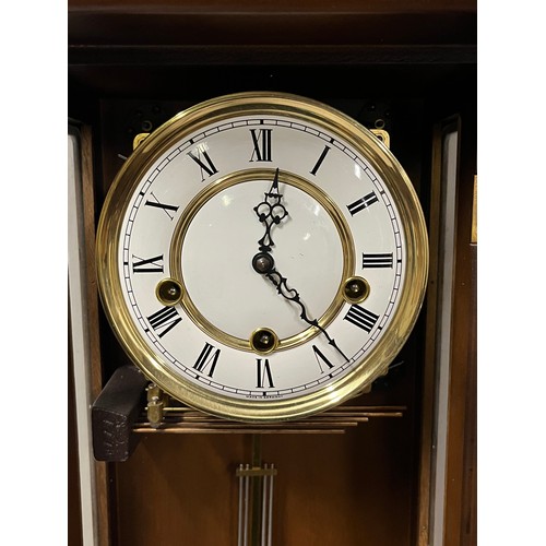 261 - Vintage mahogany wall clock with key.
84cm l