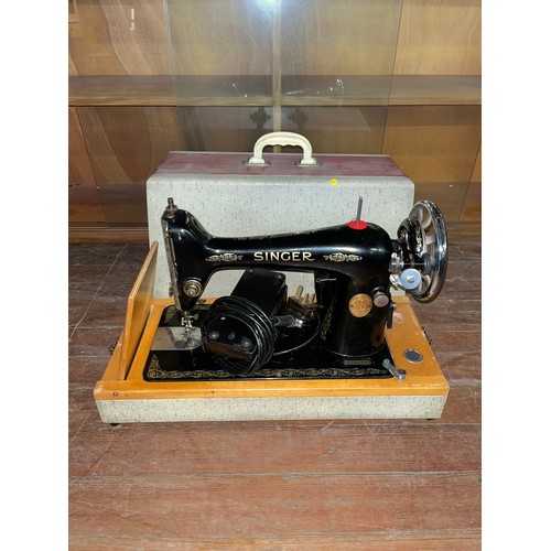 229 - Vintage electric singer sewing machine in case.