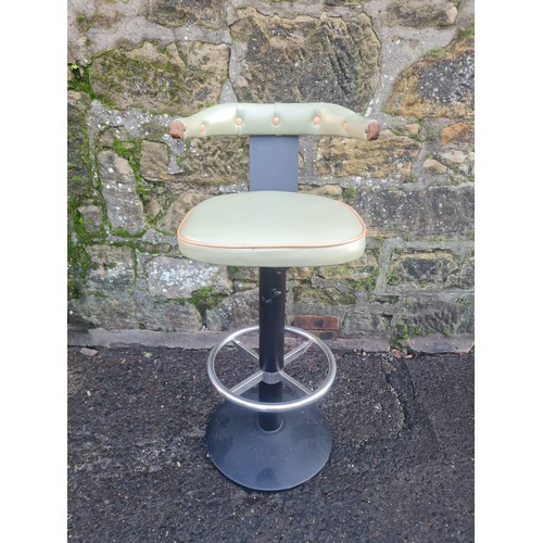 98 - Retro style swivel bar stool with green vinyl upholstery.