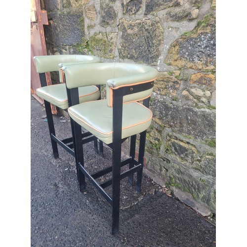 106 - Pair of green vinyl upholstered kitchen/bar stools.