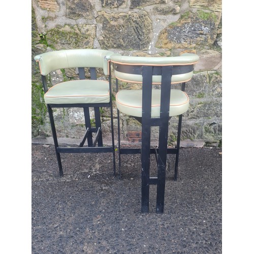 106 - Pair of green vinyl upholstered kitchen/bar stools.