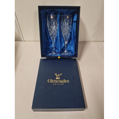 185 - Pair of Gleneagles crystal champagne flutes in fitted case.