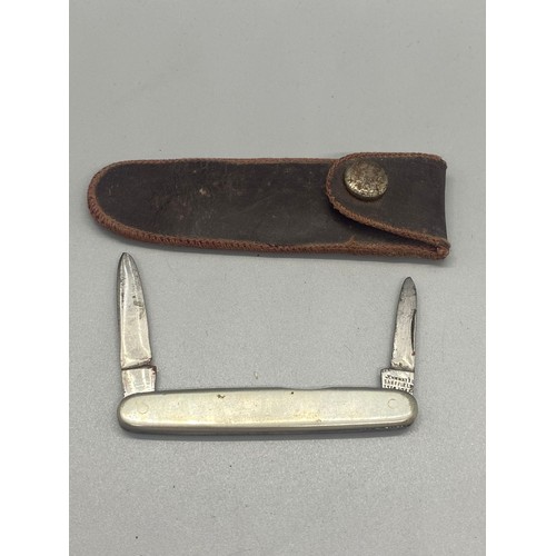 223 - Hallmarked silver John Watts pocket knife in leather sheath. 13.60g