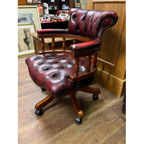 58 - Chesterfield captains chair, covered in an oxblood leather with button detail throughout slight dama... 