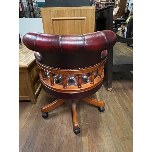 58 - Chesterfield captains chair, covered in an oxblood leather with button detail throughout slight dama... 