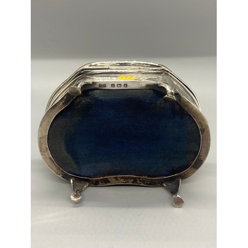 31 - Solid silver MB Hallmarked trinket box on four legs with mother of pearl flower design. 168g.