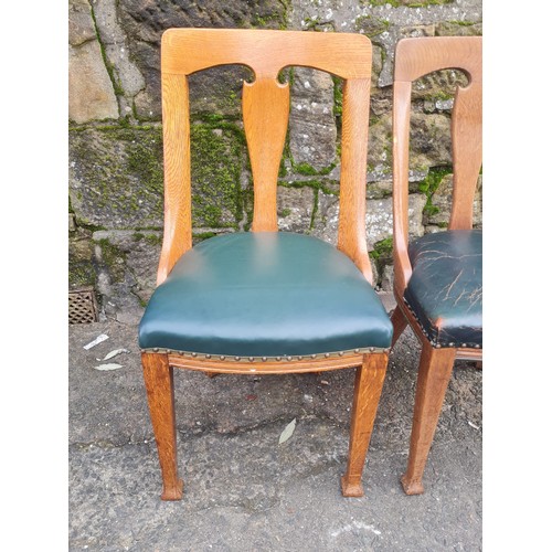 507 - pair of heavy oak green leather arts and crafts chairs.