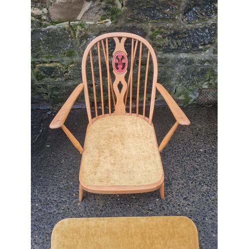 42 - Ercol Windsor upholstered Fleur de lys chair with rare matching footstool.