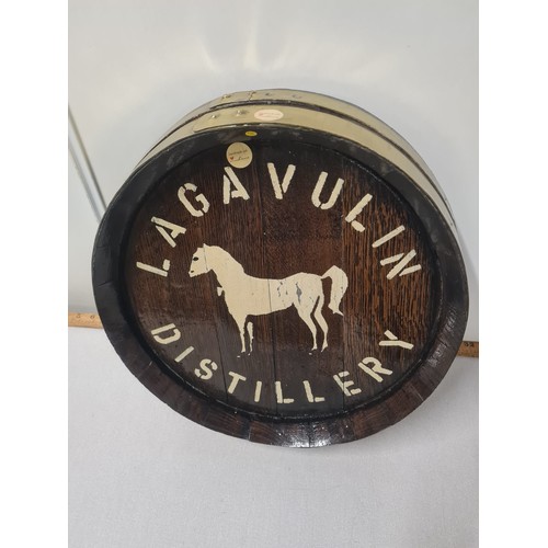 87 - brass bound wooden barrel lid with lagavulin distillery
42cm diameter